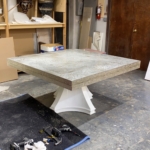Custom hammered metal dining room table edges. In polished nickel finish.