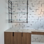 Custom bar hanging system. Dark antique brass. Satin lacquer coat. Glass and matched integrated hardware on the cabinets. Metal Work. RBL METALS - Wood Working for this project New Day Woodwork.
