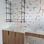 Custom bar hanging system. Dark antique brass. Satin lacquer coat. Glass and matched integrated hardware on the cabinets. Metal Work. RBL METALS - Wood Working for this project New Day Woodwork.