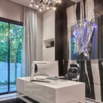Custom high gloss white lacquer desk. With polished stainless steel metal inlay By Rbl Metals at the base. All hand made.