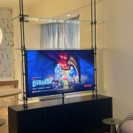 Custom NYC tv unit /divider. Tv on one side. Mirror on the other. Metal and glass By RBL We also did the integrated hardware on the cabinet . One stop shops. Woodwork for this project New Day Woodwork.