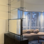 Custom NYC tv unit /divider. Tv on one side. Mirror on the other. Metal and glass By RBL We also did the integrated hardware on the cabinet . One stop shops. Woodwork for this project New Day Woodwork.