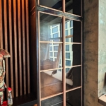 Custom copper and glass doors with unique integrated hardware style. Copper metal inlays and frames also all By Rbl Metals Design Credit Drew Mcgukin WoodWork for this project New Day Woodwork