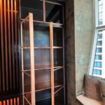Custom copper and glass doors with unique integrated hardware style. Copper metal inlays and frames also all By Rbl Metals Design Credit Drew Mcgukin WoodWork for this project New Day Woodwork