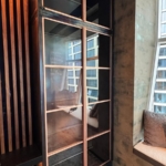 Custom copper and glass doors with unique integrated hardware style. Copper metal inlays and frames also all By Rbl Metals Design Credit Drew Mcgukin WoodWork for this project New Day Woodwork