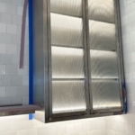 Custom brushed stainless steel and glass ceiling hung upper kitchen Cabinets. All hand made