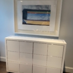 Custom white lacquer and polishing the steel with mechanized lift TV cabinets for a project in New York