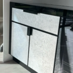 Custom polished stainless steel toe caps for a conference table.