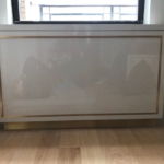 Custom lacquer and brass radiator enclosure.