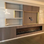 RBL Metals made the brushed brass elements & tv frame on this white lacquer. And. Grey walnut nyc living room built-in.