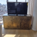 Custom antique brass rounded tv Cabinet. With mechanized lift. One of a kind.